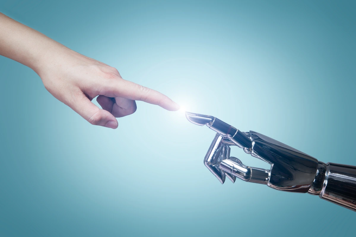 imagem que remete a inteligencia artificial com a mao de uma pessoa tocando a mao de um robo, simbolizando o contato que temos com a soph.ia da twygo